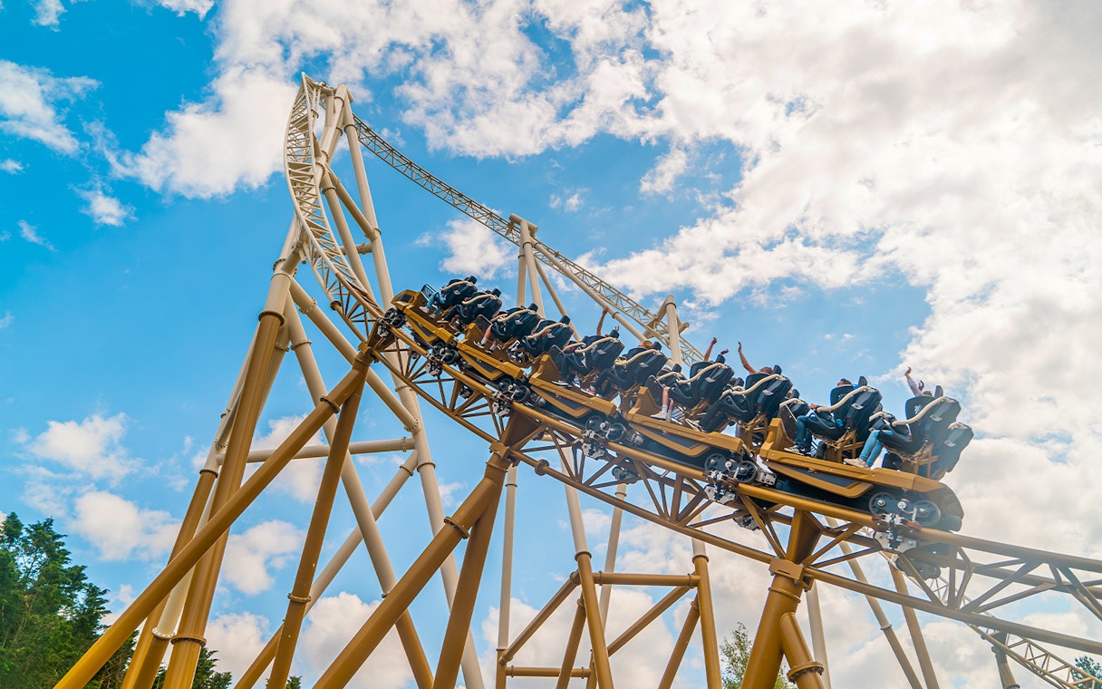 Roller coaster ascending steep track at Rides Wide, Thorpe Park.