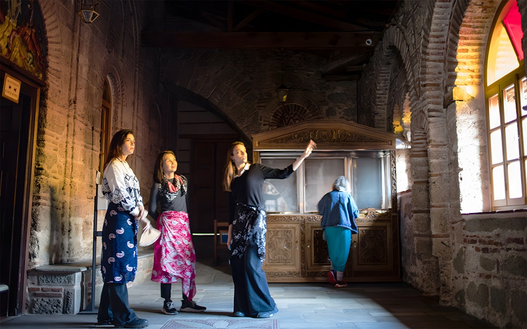 Visitors inside a Meteora monastery during a 1-day tour from Athens by train.