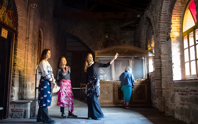 Visitors inside a Meteora monastery during a 1-day tour from Athens by train.