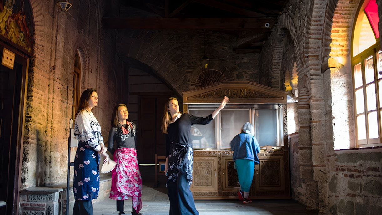 Visitors inside a Meteora monastery during a 1-day tour from Athens by train.