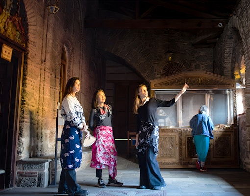 A tour guide giving information to tourist during Meteora Monasteries Full-Day Guided Tour