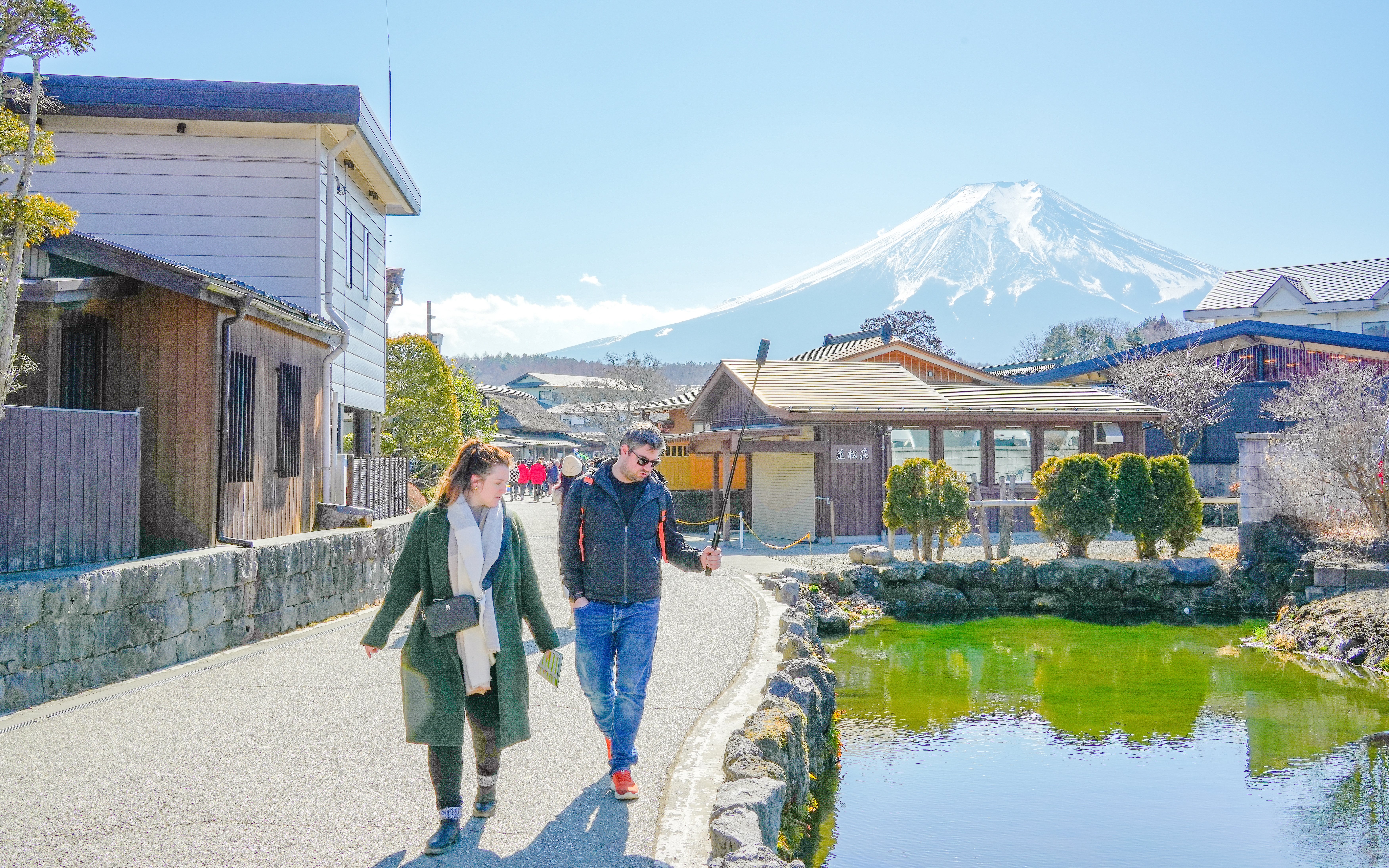 People walking along a path with Mount Fuji in the background, Japan.