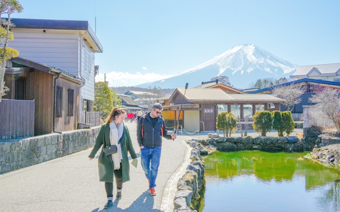 People walking along a path with Mount Fuji in the background, Japan.
