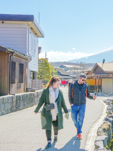 People walking along a path with Mount Fuji in the background, Japan.