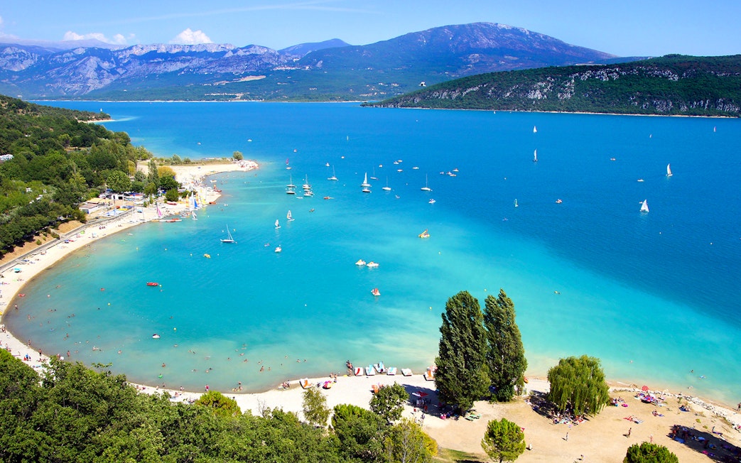Aerial view of Lake Saint Croix with sailboats and beachgoers.