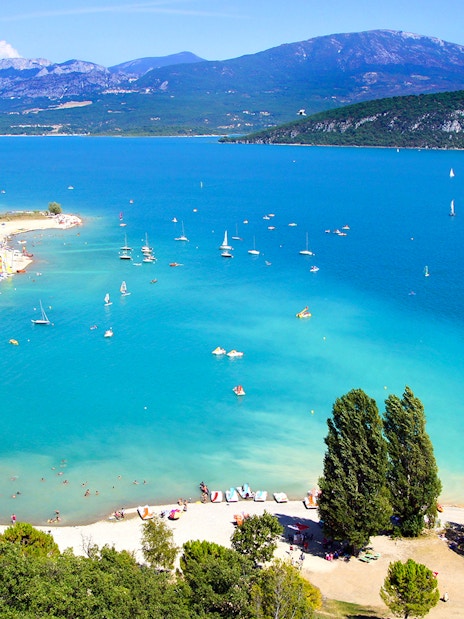 Aerial view of Lake Saint Croix with sailboats and beachgoers.