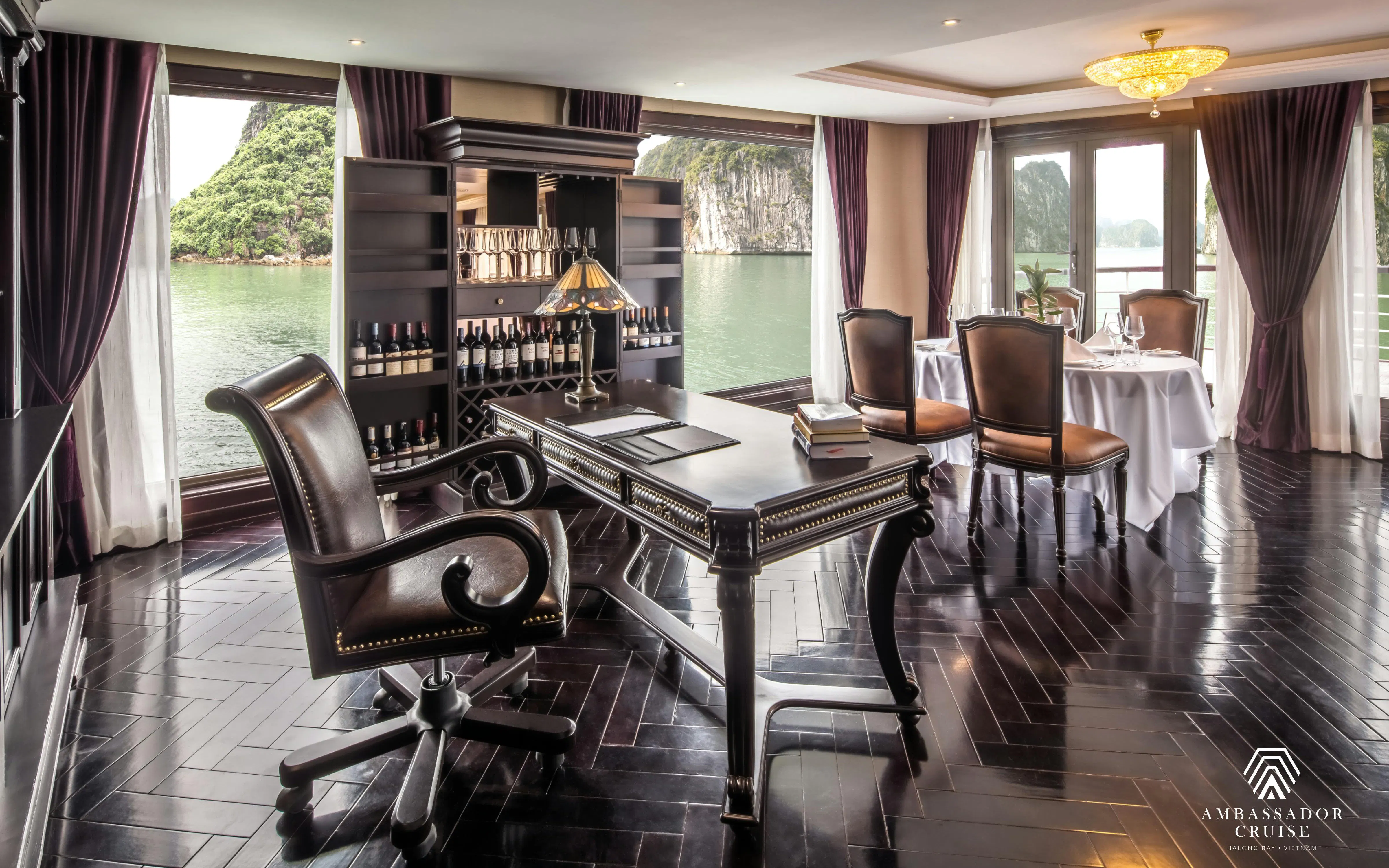 Luxurious dining and study area on Ha Long Bay 5-Star Ambassador Cruise with scenic views.