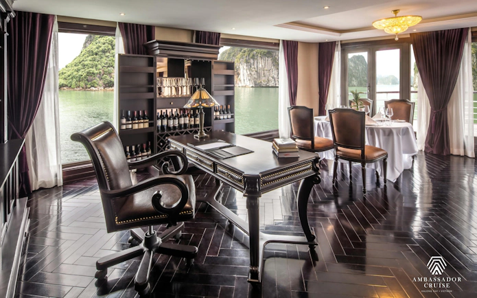 Luxurious dining and study area on Ha Long Bay 5-Star Ambassador Cruise with scenic views.