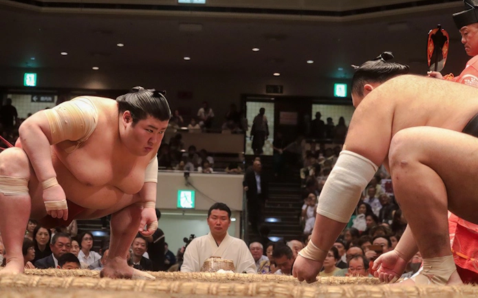 Sumo wrestlers face off in a match at a Tokyo arena.
