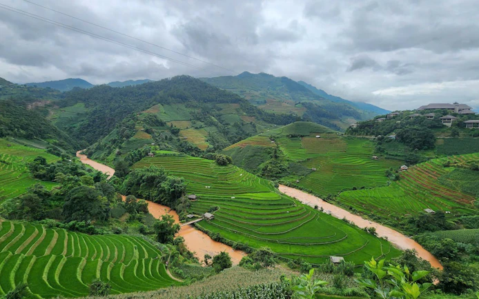 Terraced rice fields and river in Mu Cang Chai, Vietnam, viewed during a private car tour.