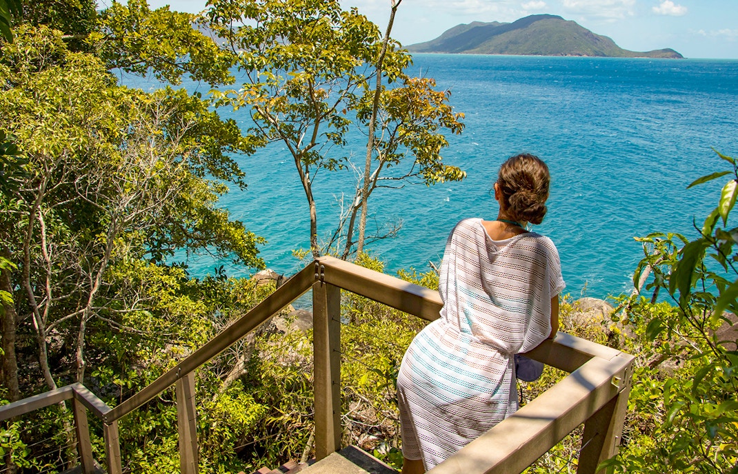 Woman overlooking the sea through a small lookout spot