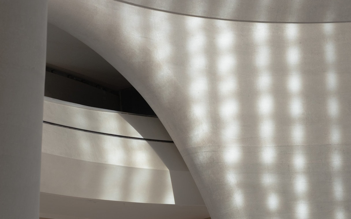 Curved architectural detail of Zayed National Museum exterior in Abu Dhabi.