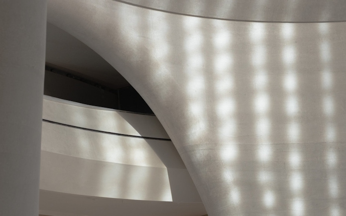 Curved architectural detail of Zayed National Museum exterior in Abu Dhabi.