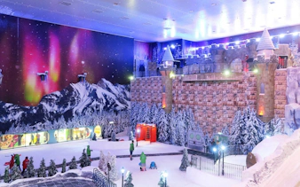 Genting Highlands Snow World Theme Park with snowy landscape and castle backdrop.