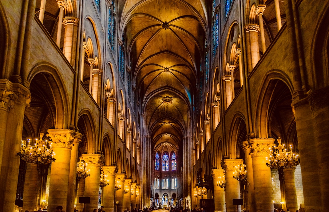 Notre Dame Cathedral interior with architecture emphasizing on stone carvings, gargoyles, and grand vaults.