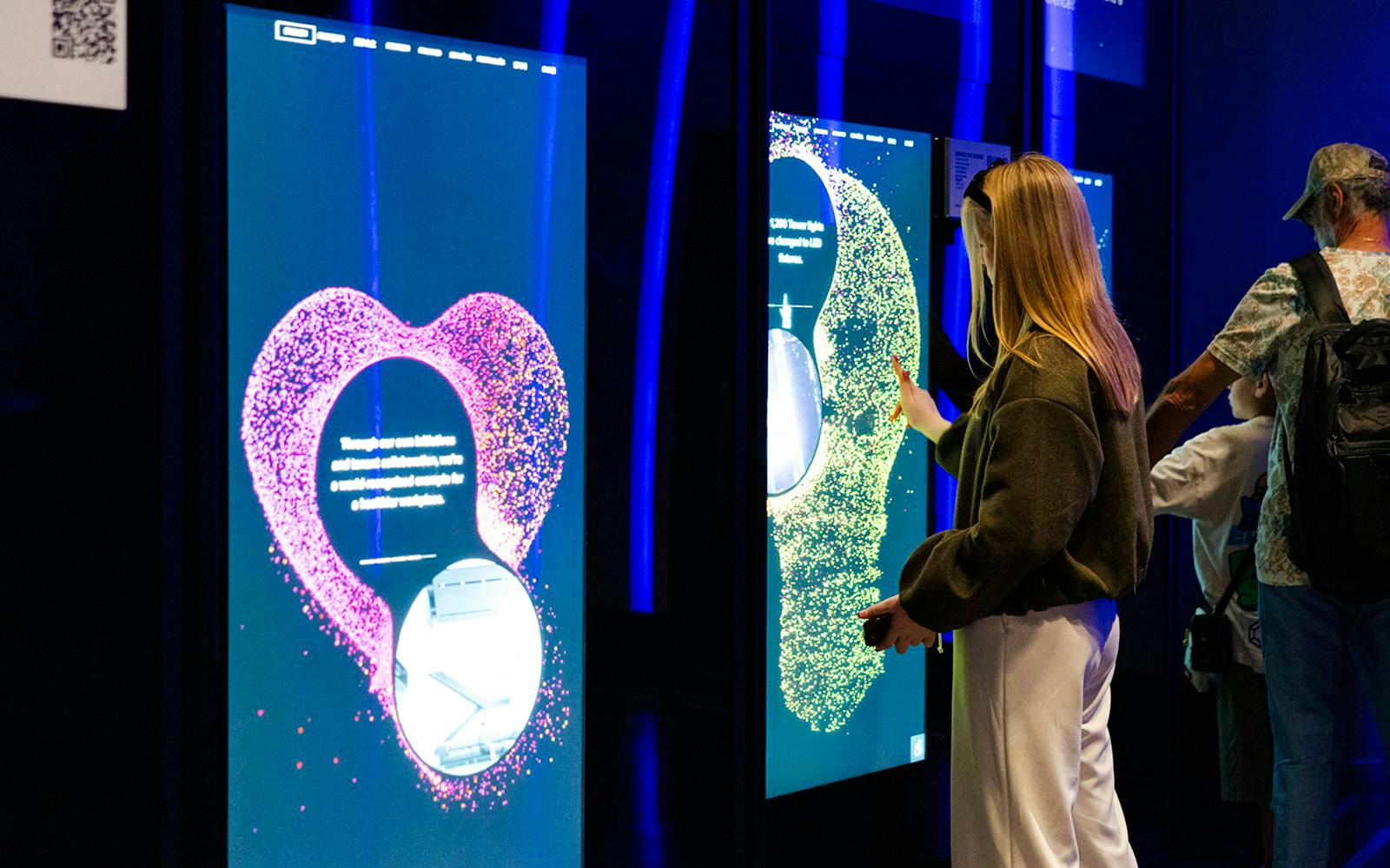 Interactive exhibit at Empire State Building with visitors engaging with digital displays.