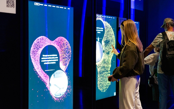 Interactive exhibit at Empire State Building with visitors engaging with digital displays.