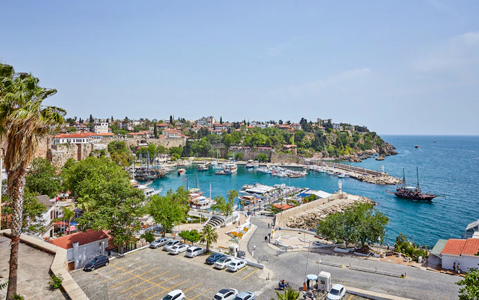 Antalya old town harbor with boats and historic buildings, sightseeing city tour.