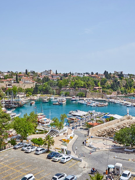 Antalya old town harbor with boats and historic buildings, sightseeing city tour.