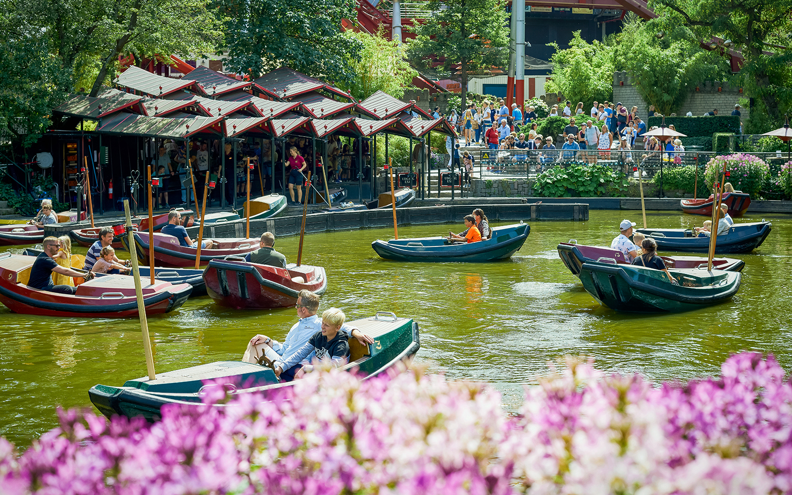 Boats with visitors on a pond at Tivoli Gardens, Copenhagen.