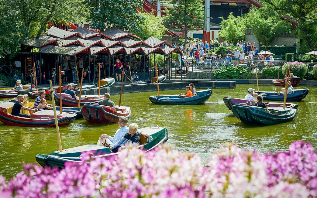 Boats with visitors on a pond at Tivoli Gardens, Copenhagen.