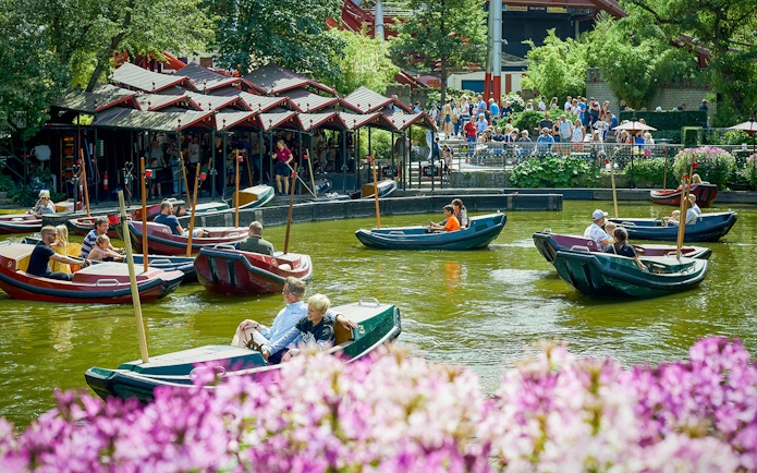 Boats with visitors on a pond at Tivoli Gardens, Copenhagen.
