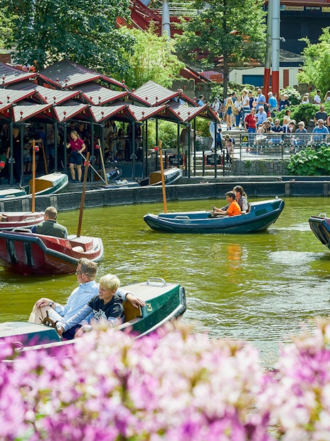 Boats with visitors on a pond at Tivoli Gardens, Copenhagen.