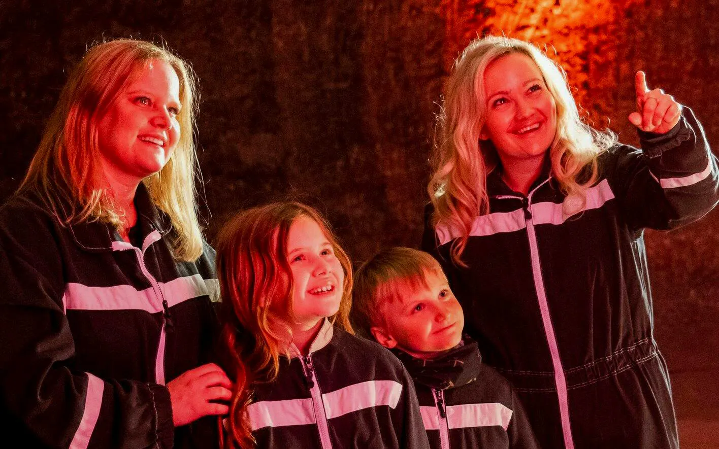 Guests in protective suits exploring Berchtesgaden Salt Mine.