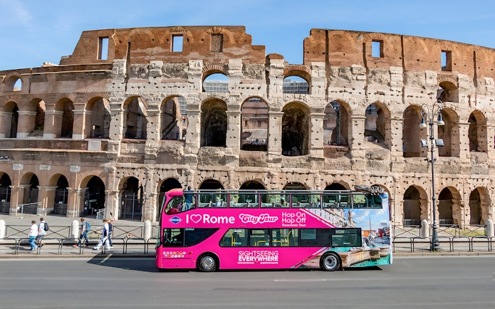 Hop-on hop-off bus in front of the Colosseum, Rome.