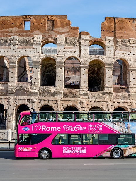 Hop-on hop-off bus in front of the Colosseum, Rome.