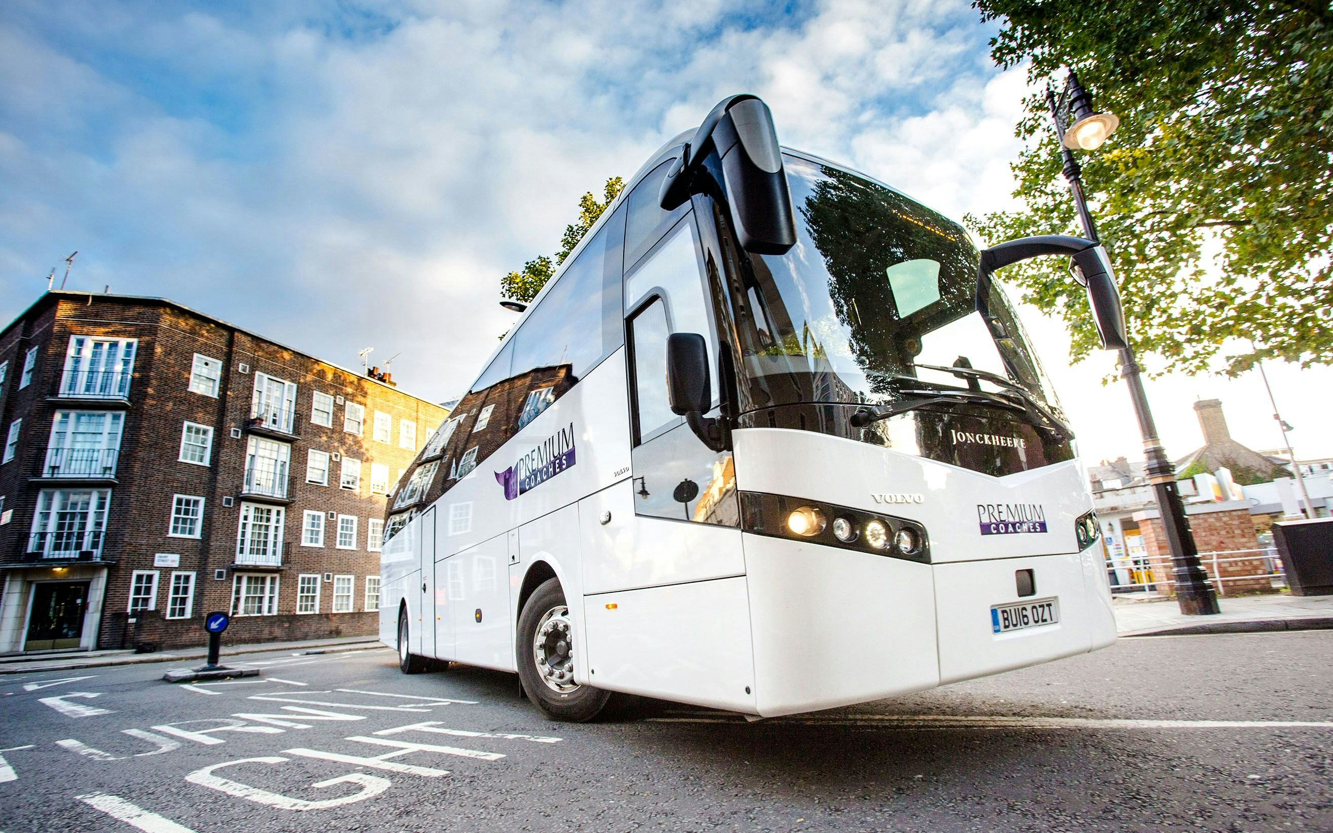 Coach for Stonehenge Day Trip from London parked on city street.