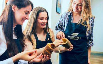 Participants enjoying a Kürtőskalács workshop in Budapest.