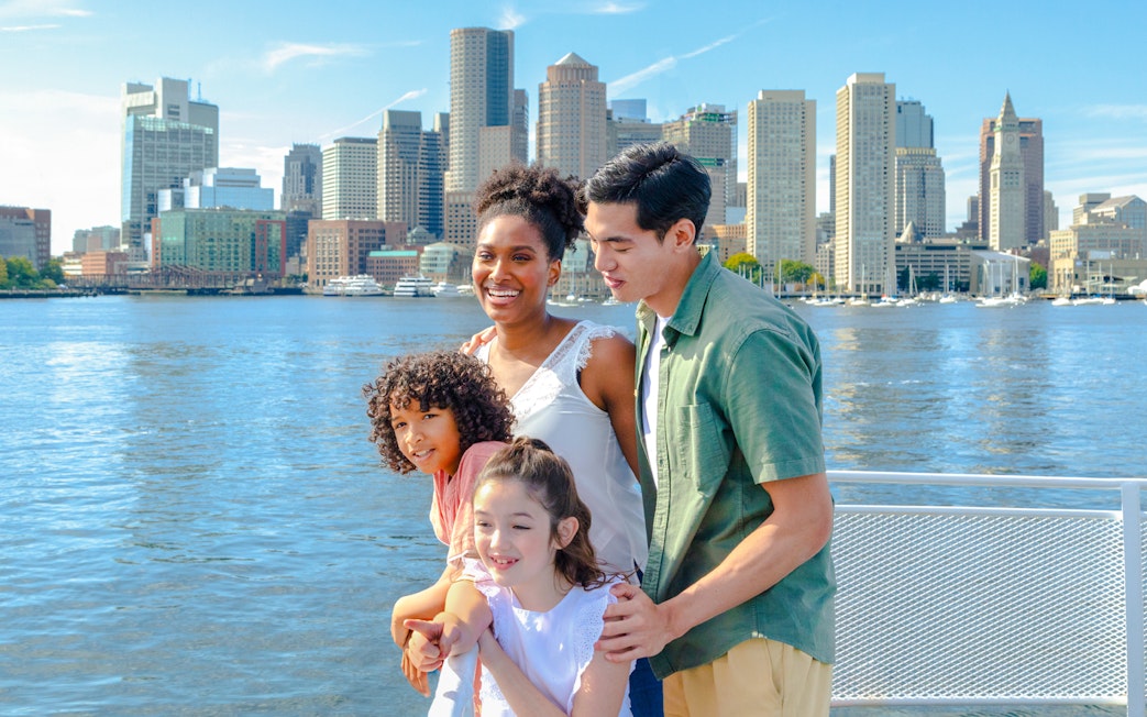 Guests enjoying the view of Boston skyline on a historic harbor cruise.