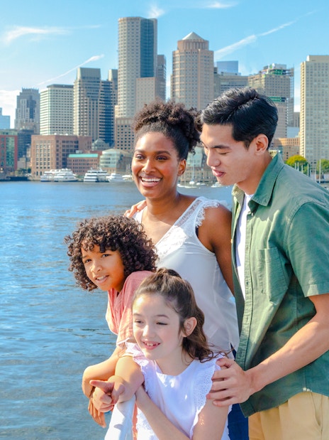 Guests enjoying the view of Boston skyline on a historic harbor cruise.