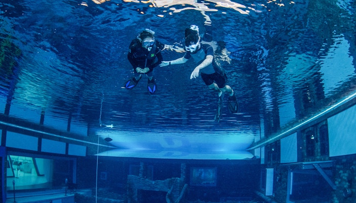 Snorkelers exploring underwater at Deep Dive Dubai.