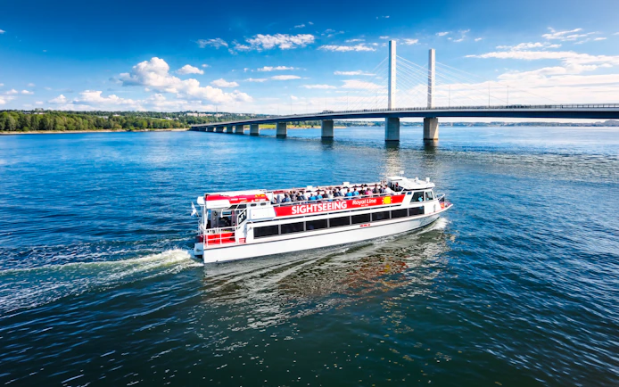 Sightseeing cruise boat near Kruununvuorensilta bridge, Finland.