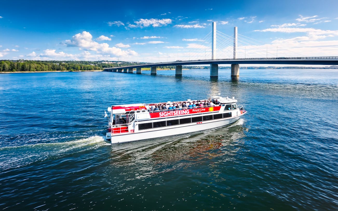 Sightseeing cruise boat near Kruununvuorensilta bridge, Finland.