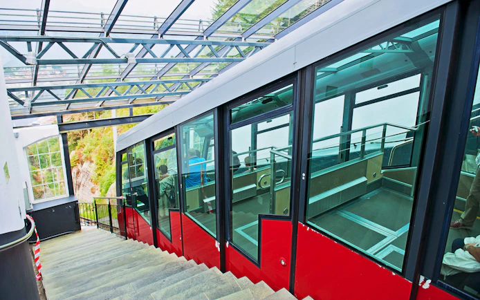 Funicular at Mount Floyen station in Bergen, Norway, with passengers inside.