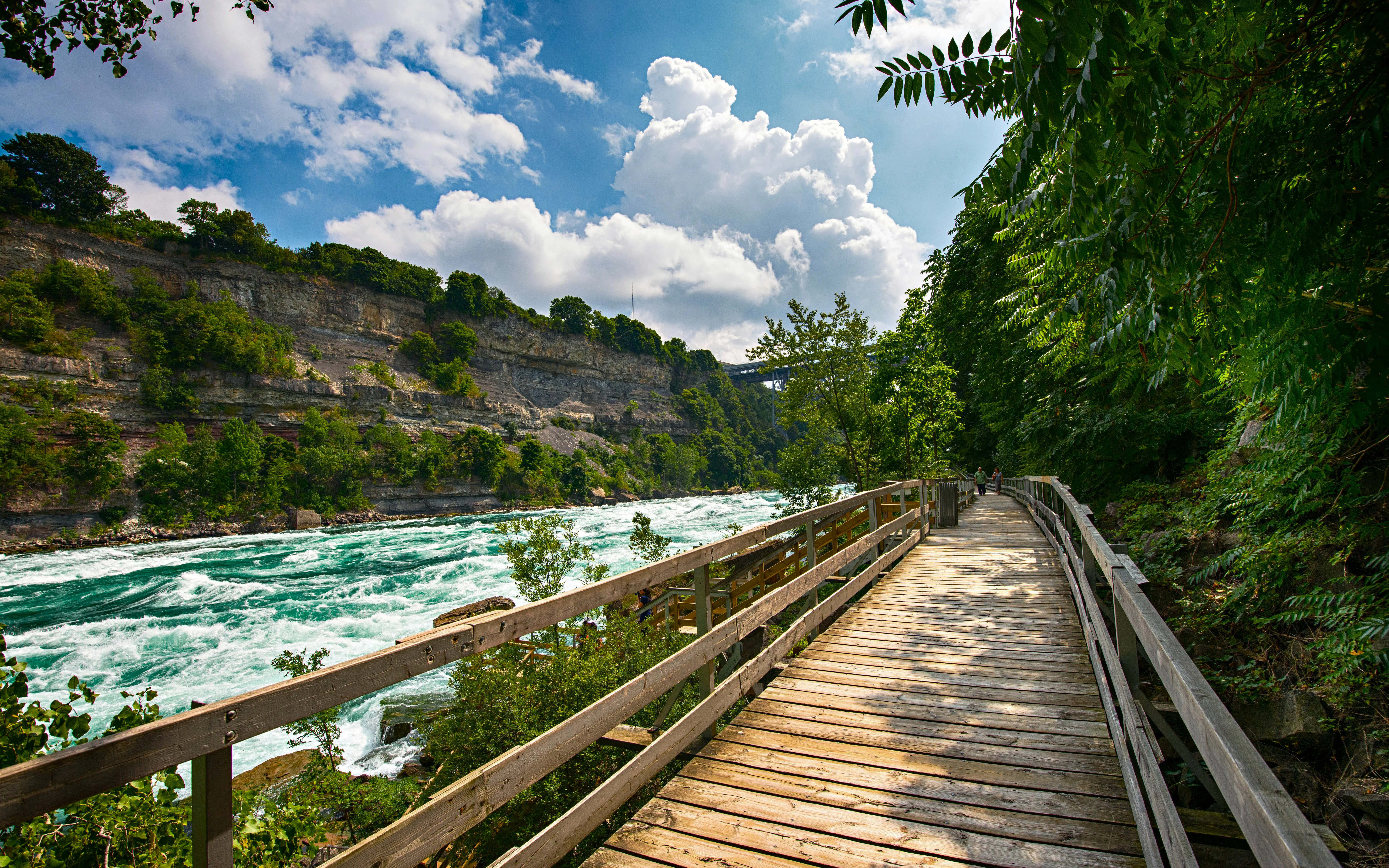 Wooden walkway beside white water rapids in Niagara Gorge.