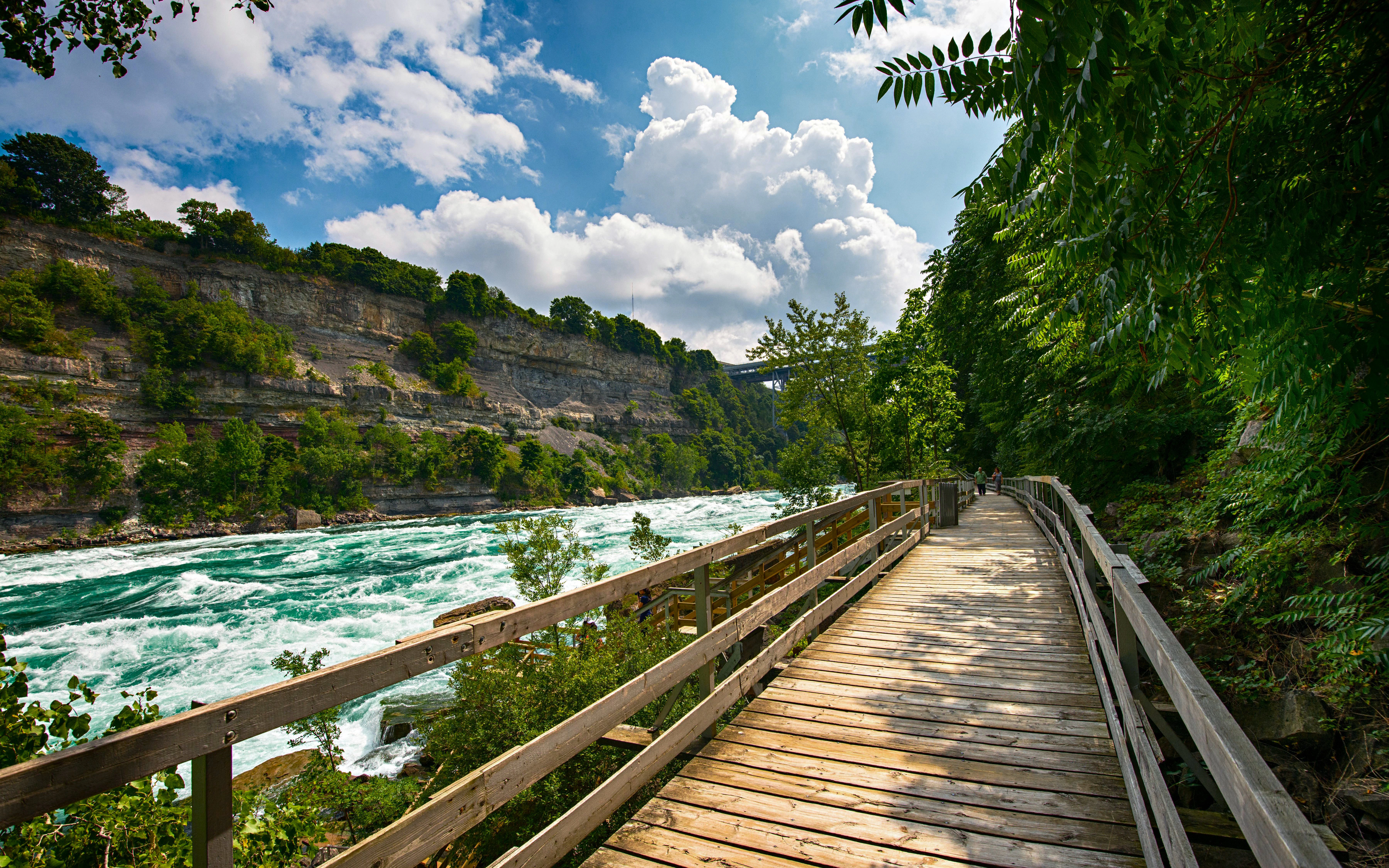 Wooden walkway beside white water rapids in Niagara Gorge.