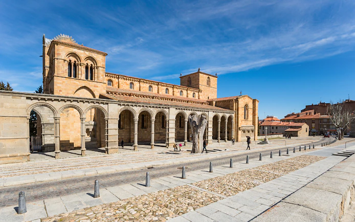 Basilica de San Vicente in Ávila, Spain, with Romanesque arches and stone facade.
