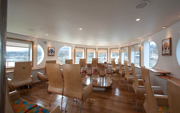 Interior of Lake Yamanaka Swan Lake cruise ship with wooden seating and large windows.