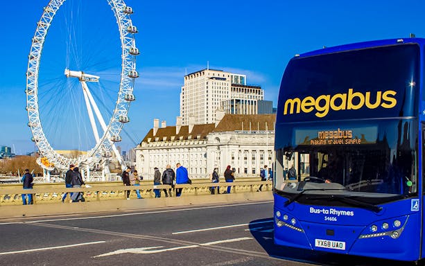 Megabus in front of the London Eye, offering airport transfer service.