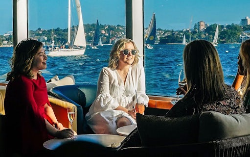 Guests enjoying drinks on a yacht during the Sydney to Hobart Yacht Race Lunch Cruise.