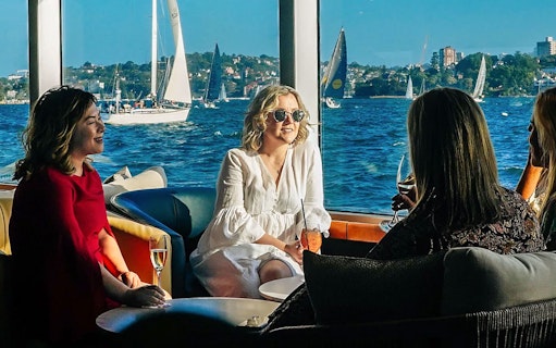Guests enjoying drinks on a yacht during the Sydney to Hobart Yacht Race Lunch Cruise.
