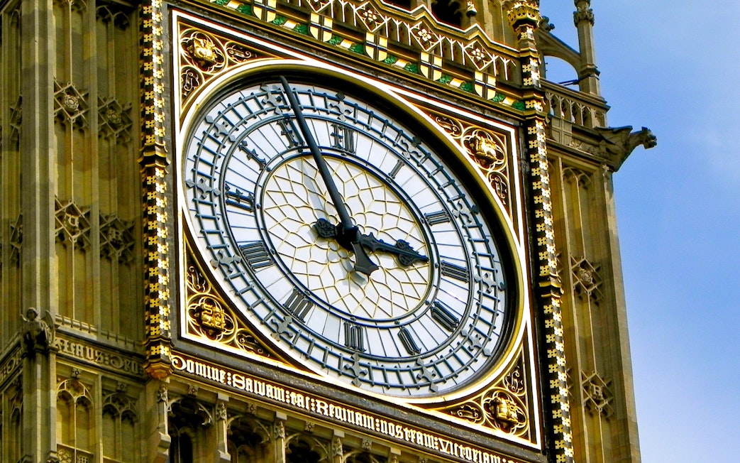 Close-up of Big Ben clock face in London, showing Roman numerals and ornate details.