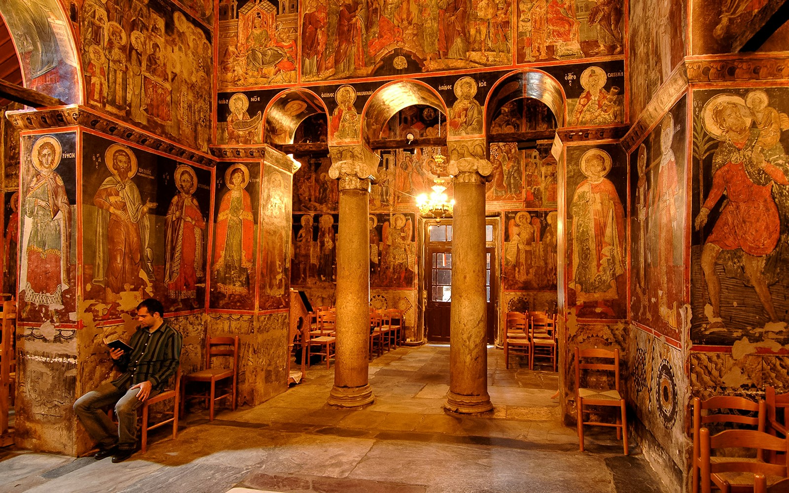 Interior of the Monastery of Varlaam with frescoes and stone columns, Greece.