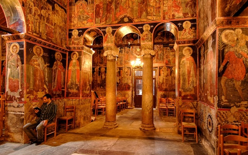 Interior of the Monastery of Varlaam with frescoes and stone columns, Greece.