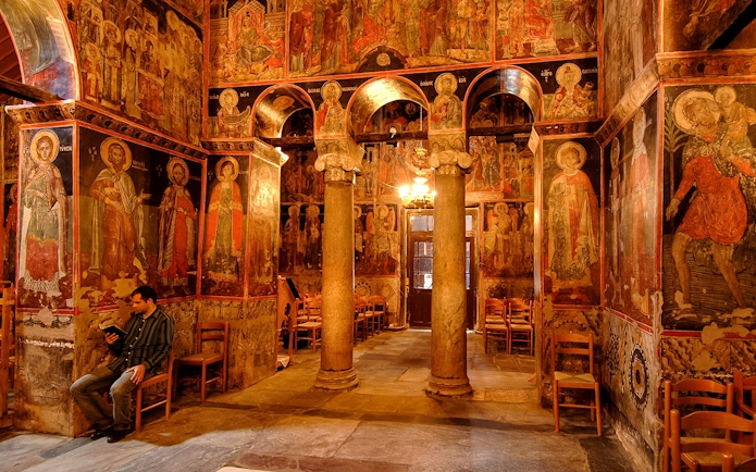 Interior of the Monastery of Varlaam with frescoes and stone columns, Greece.