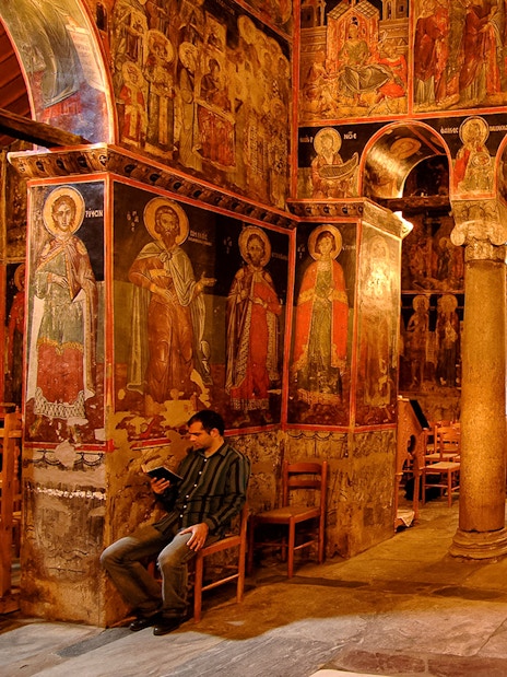 Interior of the Monastery of Varlaam with frescoes and stone columns, Greece.